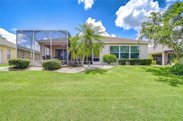 2226 N Creek Ct, Sun City Center, FL 33573 - rear view of property featuring stucco siding and a lawn