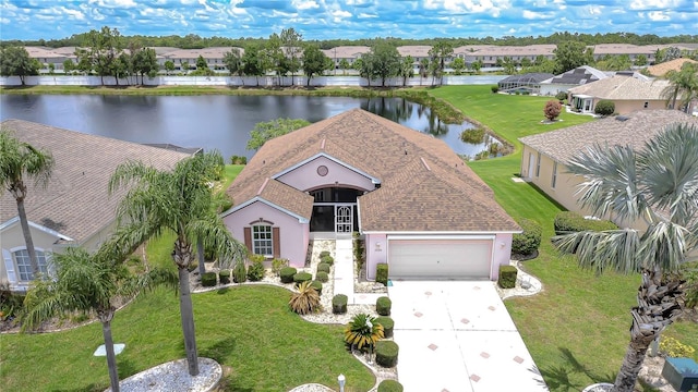 2226 N Creek Ct, Sun City Center, FL 33573 - view of front of home featuring a water view, driveway, a garage, and a residential view