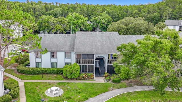 1207 Pine Ridge Cir W Unit H2, Tarpon Springs, FL 34688 - view of subject property featuring a forest