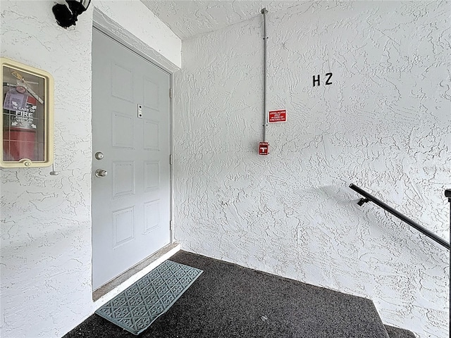 1207 Pine Ridge Cir W Unit H2, Tarpon Springs, FL 34688 - doorway to property featuring stucco siding