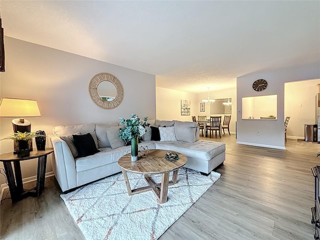 1207 Pine Ridge Cir W Unit H2, Tarpon Springs, FL 34688 - living area with wood finished floors and a chandelier
