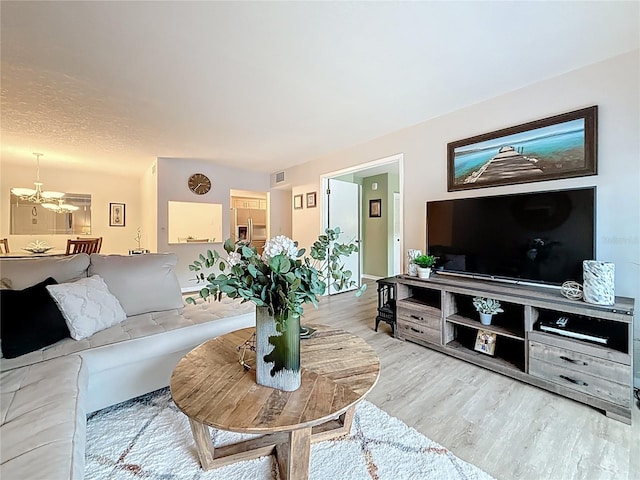 1207 Pine Ridge Cir W Unit H2, Tarpon Springs, FL 34688 - living room with a chandelier and wood finished floors