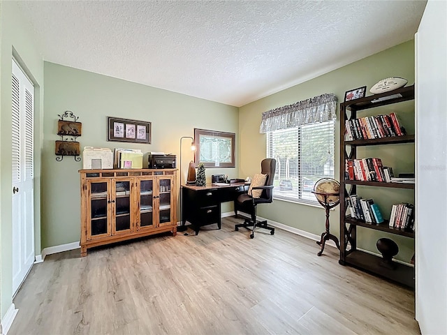 1207 Pine Ridge Cir W Unit H2, Tarpon Springs, FL 34688 - office area featuring wood finished floors and a textured ceiling