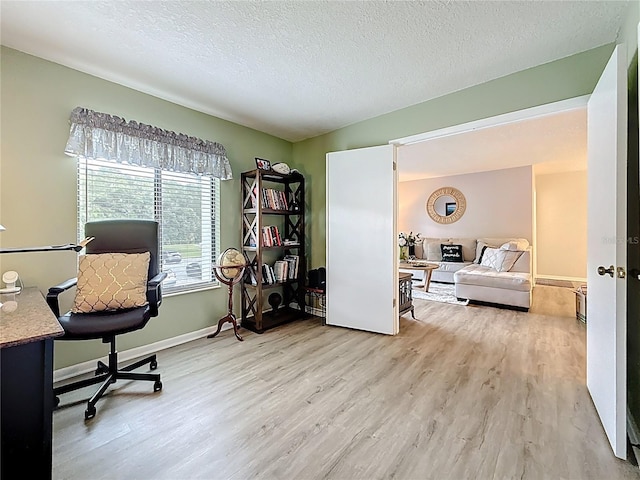 1207 Pine Ridge Cir W Unit H2, Tarpon Springs, FL 34688 - home office with light wood-type flooring and a textured ceiling