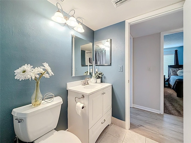 1207 Pine Ridge Cir W Unit H2, Tarpon Springs, FL 34688 - ensuite bathroom with vanity and wood finished floors