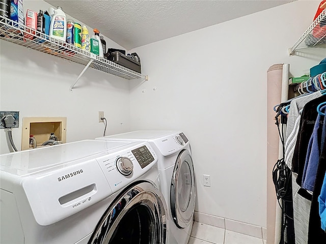 1207 Pine Ridge Cir W Unit H2, Tarpon Springs, FL 34688 - laundry room with washing machine and dryer and light tile patterned floors