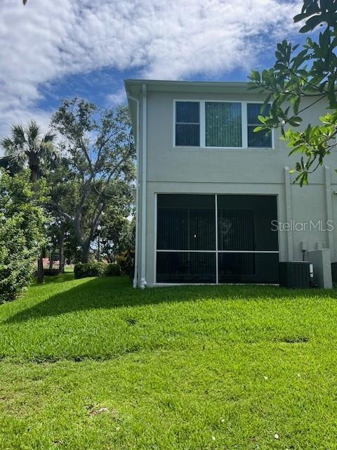 3665 Country Pointe Pl, Palm Harbor, FL 34684 - back of house with a yard and stucco siding