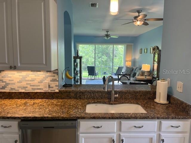 3665 Country Pointe Pl, Palm Harbor, FL 34684 - kitchen featuring stainless steel dishwasher, white cabinets, decorative backsplash, a ceiling fan, and open floor plan