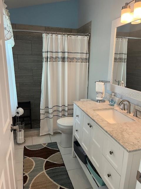 3665 Country Pointe Pl, Palm Harbor, FL 34684 - full bath with vanity, tile patterned flooring, and tiled shower