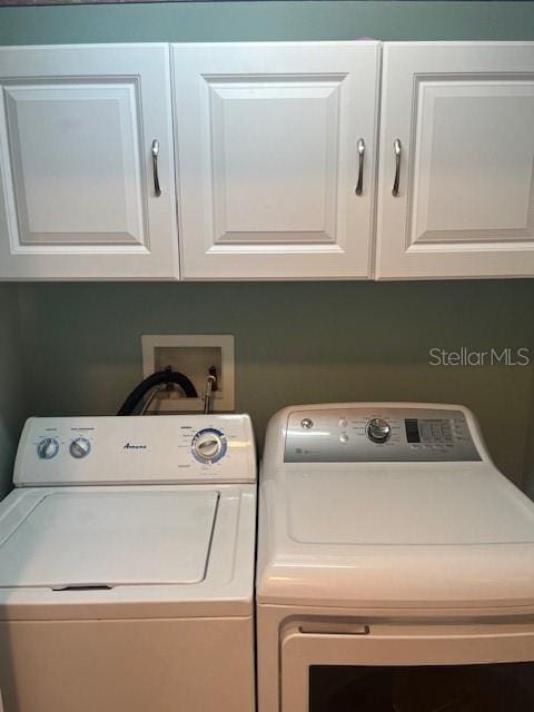 3665 Country Pointe Pl, Palm Harbor, FL 34684 - laundry room featuring washer and dryer and cabinet space