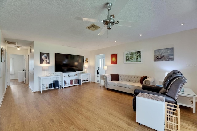 123 Glendower Cir Unit 123, Sun City Center, FL 33573 - living room featuring a ceiling fan, a textured ceiling, wood finished floors, and recessed lighting
