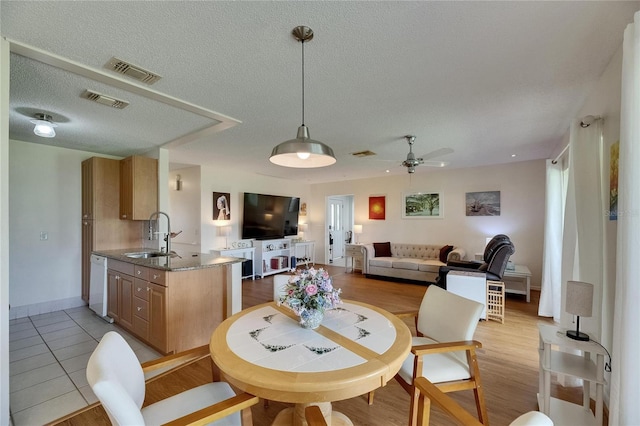 123 Glendower Cir Unit 123, Sun City Center, FL 33573 - dining room featuring a ceiling fan and a textured ceiling
