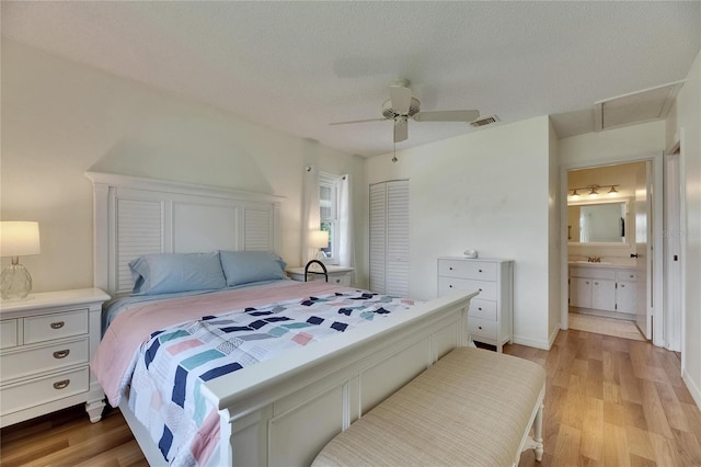 123 Glendower Cir Unit 123, Sun City Center, FL 33573 - bedroom featuring light wood-type flooring, ceiling fan, and ensuite bath