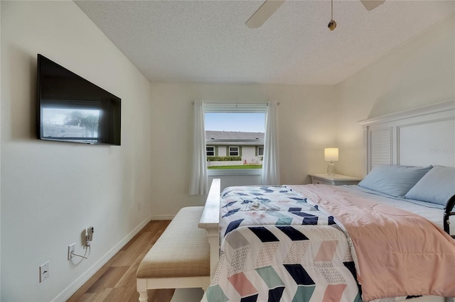 123 Glendower Cir Unit 123, Sun City Center, FL 33573 - bedroom with light wood finished floors, a textured ceiling, and a ceiling fan