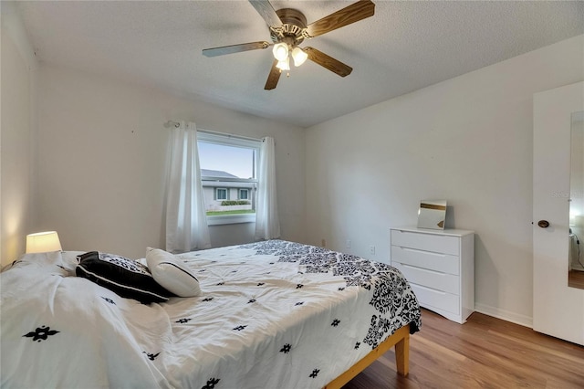 123 Glendower Cir Unit 123, Sun City Center, FL 33573 - bedroom with light wood-style floors and ceiling fan