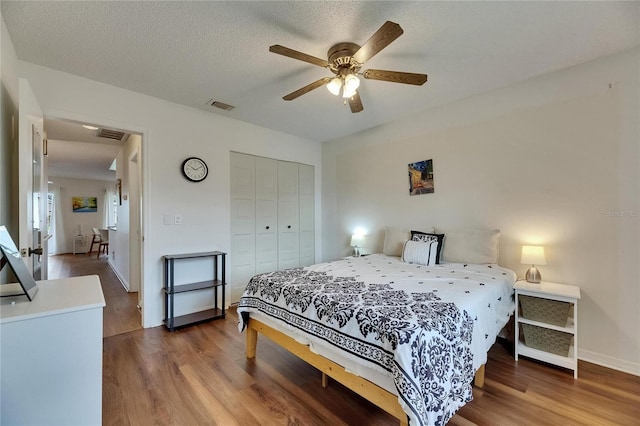 123 Glendower Cir Unit 123, Sun City Center, FL 33573 - bedroom with wood finished floors, a closet, and a ceiling fan