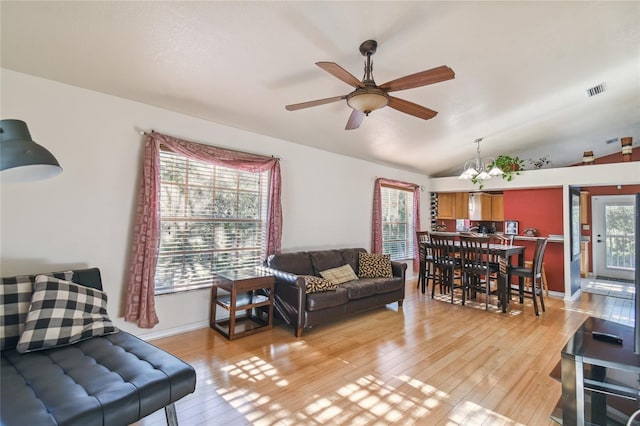 5908 Mohr Rd, Tampa, FL 33615 - living area featuring ceiling fan, light wood finished floors, a chandelier, and vaulted ceiling