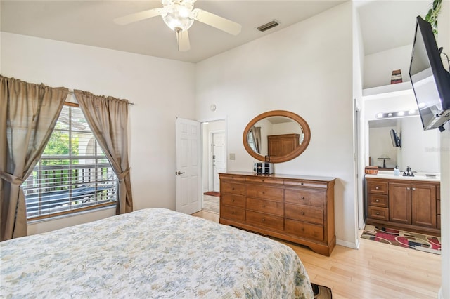 5908 Mohr Rd, Tampa, FL 33615 - bedroom with light wood-style flooring, connected bathroom, and ceiling fan