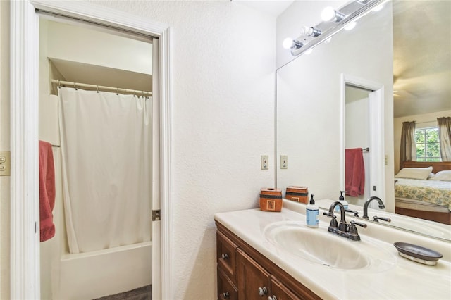 5908 Mohr Rd, Tampa, FL 33615 - full bathroom featuring vanity, ensuite bath, shower / bathtub combination with curtain, and a textured wall