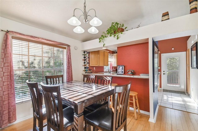 5908 Mohr Rd, Tampa, FL 33615 - dining room with a chandelier and light wood-type flooring