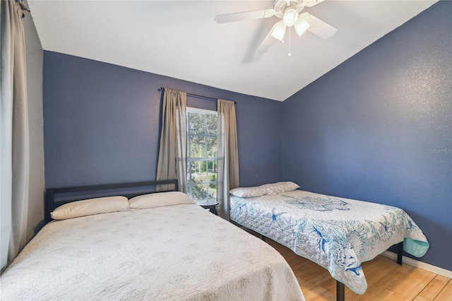 5908 Mohr Rd, Tampa, FL 33615 - bedroom featuring wood finished floors, vaulted ceiling, and a ceiling fan