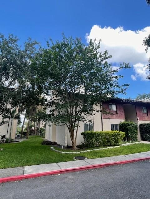 8636 Tahoe Ct Unit 13, Tampa, FL 33614 - view of side of home with stucco siding and a lawn