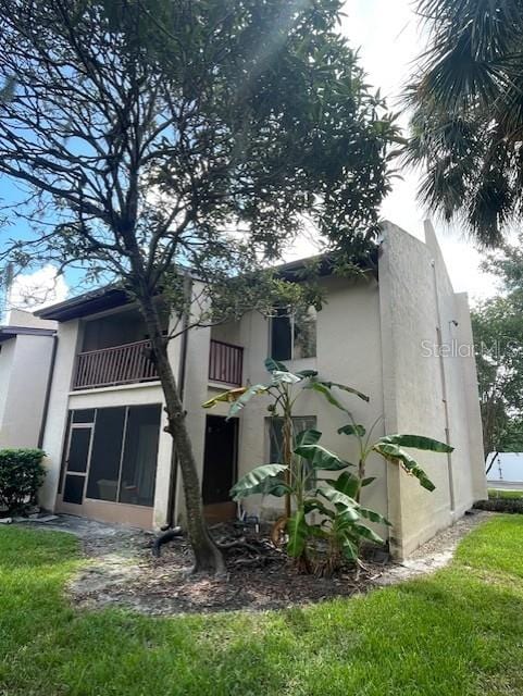 8636 Tahoe Ct Unit 13, Tampa, FL 33614 - rear view of house with a balcony and stucco siding