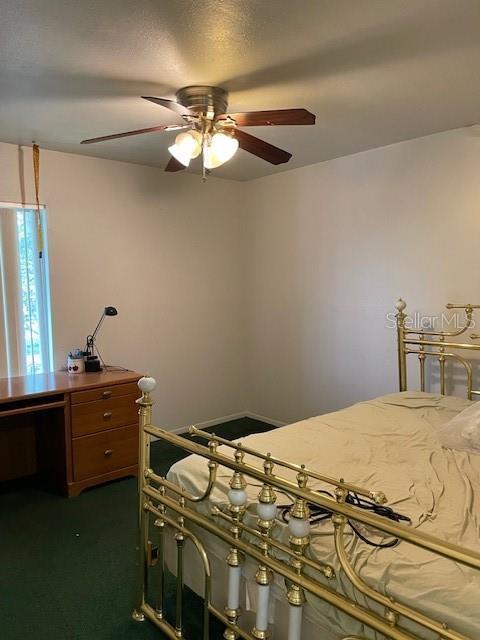 8636 Tahoe Ct Unit 13, Tampa, FL 33614 - bedroom featuring dark colored carpet and a ceiling fan