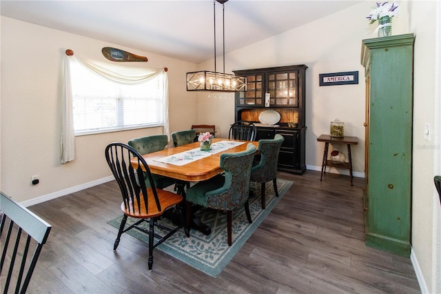 11945 Darwin Ave, New Port Richey, FL 34654 - dining area featuring vaulted ceiling, dark wood-type flooring, and a chandelier