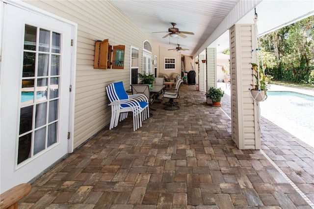 11945 Darwin Ave, New Port Richey, FL 34654 - view of patio featuring ceiling fan, outdoor dining space, and an outdoor pool