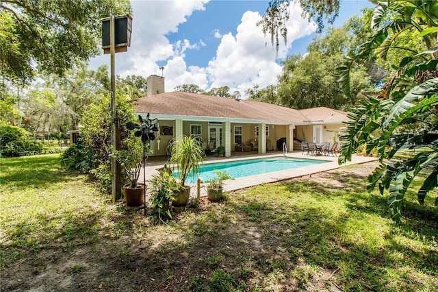 11945 Darwin Ave, New Port Richey, FL 34654 - outdoor pool featuring a patio and a lawn