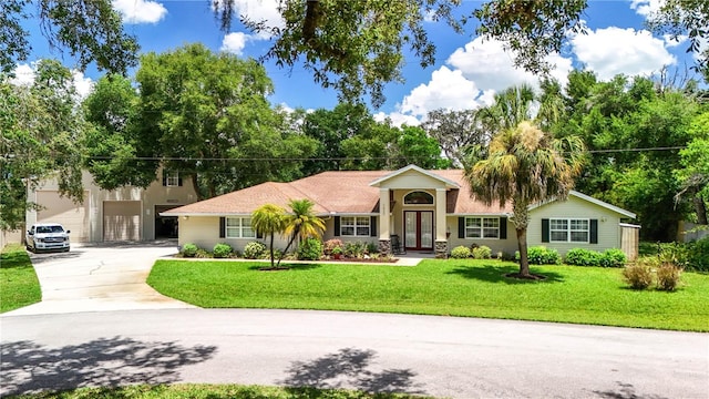 11945 Darwin Ave, New Port Richey, FL 34654 - ranch-style house with driveway, a front yard, an attached garage, and french doors