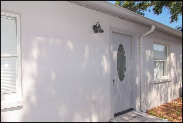 1004 Osage St, Clearwater, FL 33755 - view of exterior entry with stucco siding