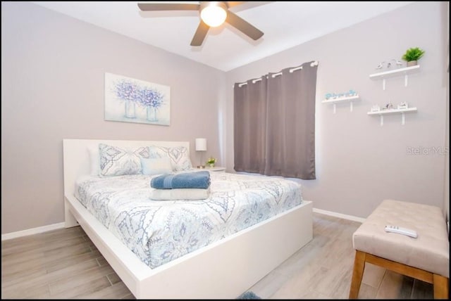 1004 Osage St, Clearwater, FL 33755 - bedroom with light wood-style flooring and a ceiling fan