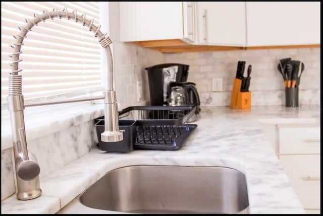 1004 Osage St, Clearwater, FL 33755 - kitchen view of tasteful backsplash, white cabinets, and a wood stove