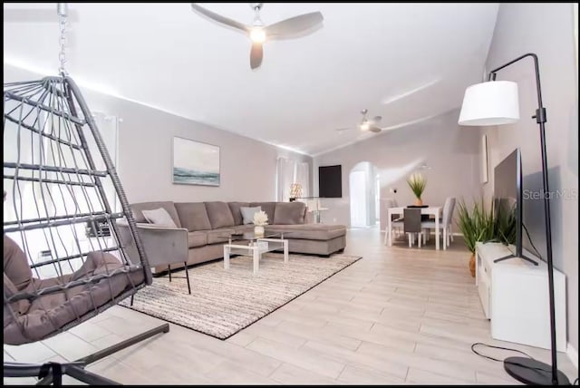 1004 Osage St, Clearwater, FL 33755 - living room with ceiling fan, arched walkways, and light wood-style floors
