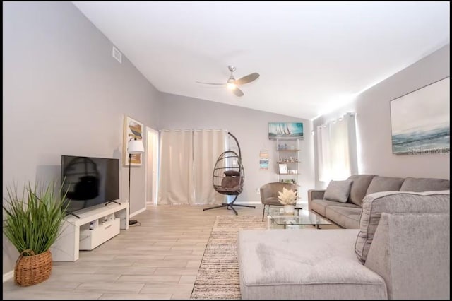 1004 Osage St, Clearwater, FL 33755 - living room featuring vaulted ceiling, ceiling fan, and light wood-style flooring