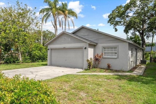 1004 Osage St, Clearwater, FL 33755 - view of front of property with an attached garage, concrete driveway, a front yard, and stucco siding
