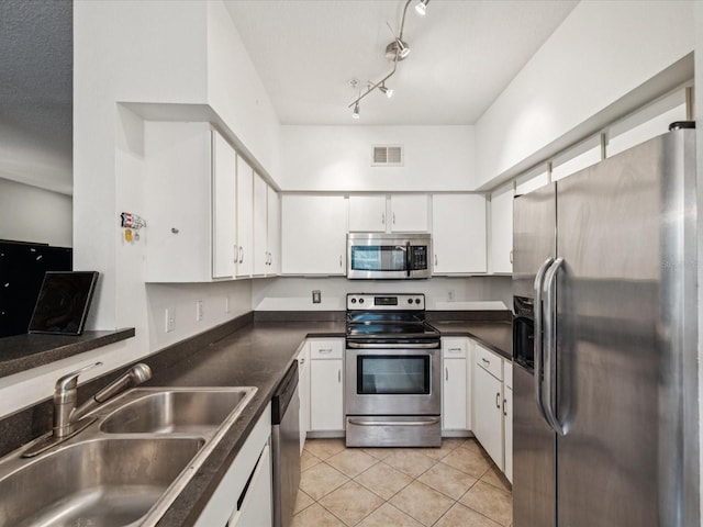 2010 E Palm Ave Unit 14303, Tampa, FL 33605 - kitchen featuring appliances with stainless steel finishes, white cabinetry, light tile patterned floors, and dark countertops