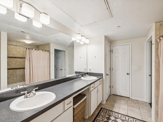 2010 E Palm Ave Unit 14303, Tampa, FL 33605 - full bathroom with double vanity, tile patterned flooring, a shower with curtain, and a textured ceiling
