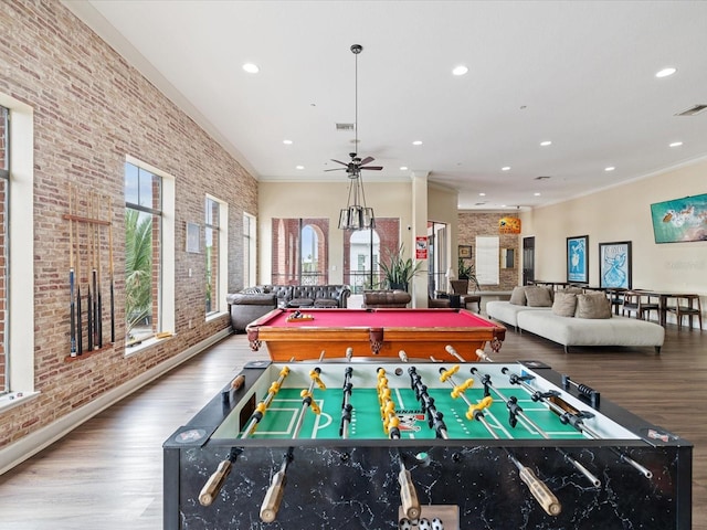 2010 E Palm Ave Unit 14303, Tampa, FL 33605 - recreation room featuring brick wall, wood finished floors, recessed lighting, ceiling fan, and crown molding