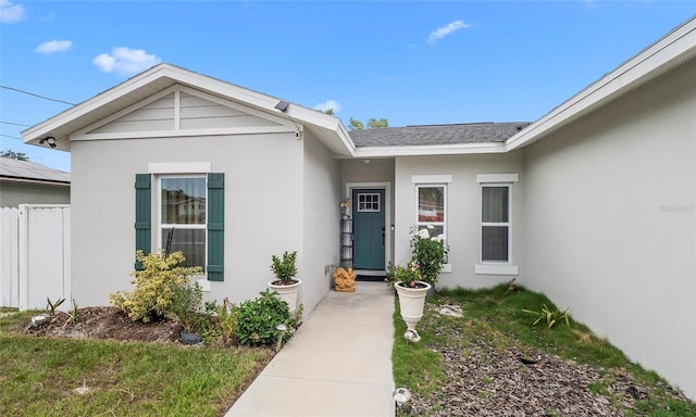 9429 Northcliffe Blvd, Spring Hill, FL 34606 - doorway to property featuring stucco siding and roof with shingles