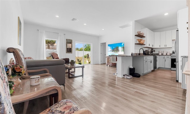 9429 Northcliffe Blvd, Spring Hill, FL 34606 - living room with light wood-style flooring and recessed lighting