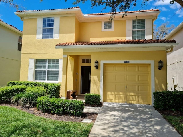 8923 Cuban Palm Rd, Kissimmee, FL 34747 - view of front of property featuring a tiled roof, stucco siding, a garage, and concrete driveway