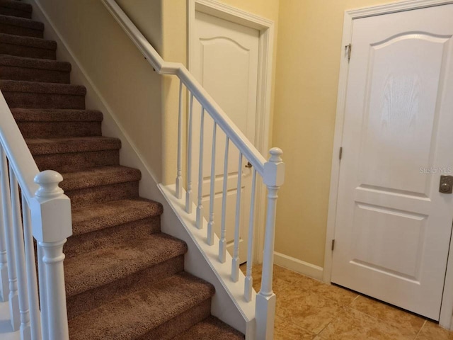 8923 Cuban Palm Rd, Kissimmee, FL 34747 - stairway with baseboards and tile patterned floors