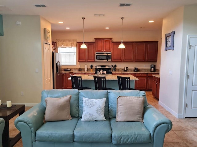 8923 Cuban Palm Rd, Kissimmee, FL 34747 - living room featuring recessed lighting and light tile patterned floors