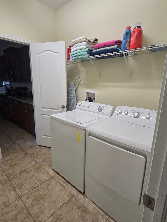 8923 Cuban Palm Rd, Kissimmee, FL 34747 - washroom featuring separate washer and dryer and light tile patterned floors