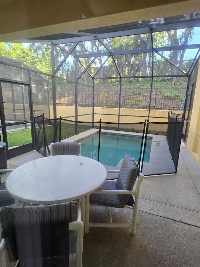 8923 Cuban Palm Rd, Kissimmee, FL 34747 - view of pool featuring glass enclosure, a patio area, outdoor dining area, and a lawn