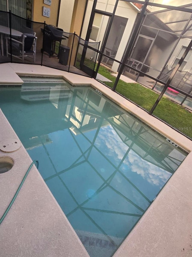 8923 Cuban Palm Rd, Kissimmee, FL 34747 - swimming pool featuring a lanai, a patio area, and a grill