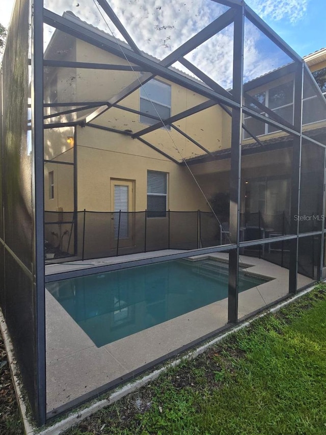 8923 Cuban Palm Rd, Kissimmee, FL 34747 - outdoor pool featuring glass enclosure and a patio
